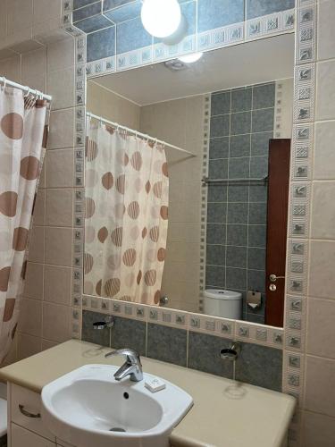 a bathroom with a sink and a mirror at DANAOS 2 COMPLEX APARTMENT - By NOMA STAYS Cyprus in Paphos