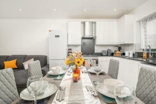 a kitchen with a table with chairs and a dining room at Large 3BR House by D3 Short Stay, Sleeps 9, Parking & Near to Tottenham Stadium in London