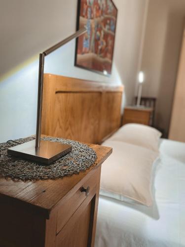 a bedroom with a bed and a desk with a laptop at L'Adret in Aosta