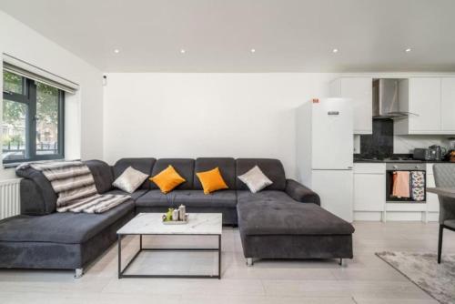 a living room with a couch and a table at Large 3BR House by D3 Short Stay, Sleeps 9, Parking & Near to Tottenham Stadium in London