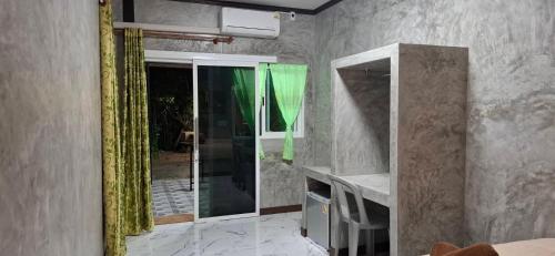 a bathroom with a glass shower in a room at Labelle House in Ko Lanta