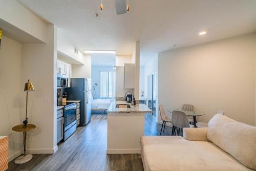 a kitchen and living room with a couch and a table at Stylish Studio-1BR 1BA, Pool, Gym, Free Parking, Game Room, EV in Tempe
