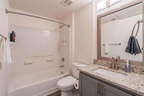a bathroom with a sink and a tub and a toilet at Stylish Studio-1BR 1BA, Pool, Gym, Free Parking, Game Room, EV in Tempe