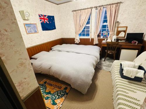 Ένα ή περισσότερα κρεβάτια σε δωμάτιο στο Echoland Madarao エコーランド斑尾 All en-suite rooms & a free 3-minute shuttle to the ski resort