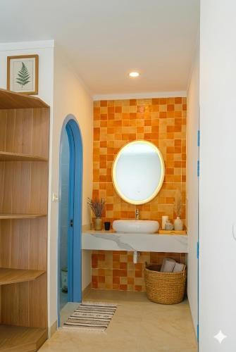 a bathroom with a sink and a mirror at Homestay Santoni Mũi Né in Mui Ne