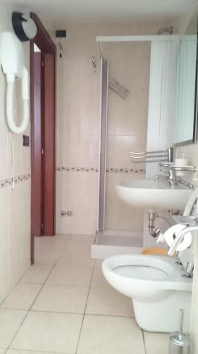 a bathroom with a toilet and a sink at Hotel Holiday House in San Giovanni Rotondo