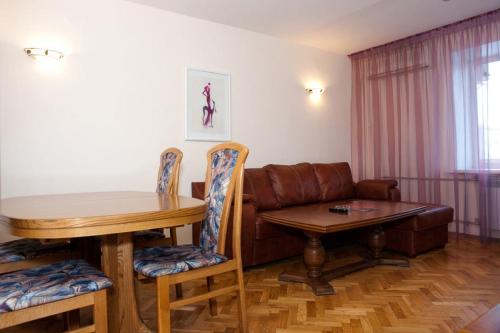 a living room with a couch and a table at Apart-Hotel Zagreb in Saratov