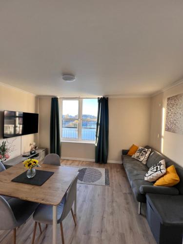 a living room with a couch and a table at Whole Flat - Free Parking - Cathedral & Canal View in Lincoln