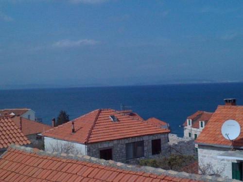 a view of roofs of houses and the ocean at Apartments Jere in Sutivan