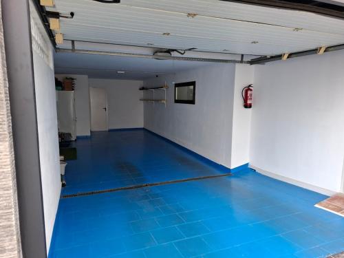a hallway with a blue floor in a building at Villa Corni in La Zubia