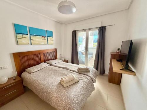 En eller flere senge i et værelse på Hacienda Apartment