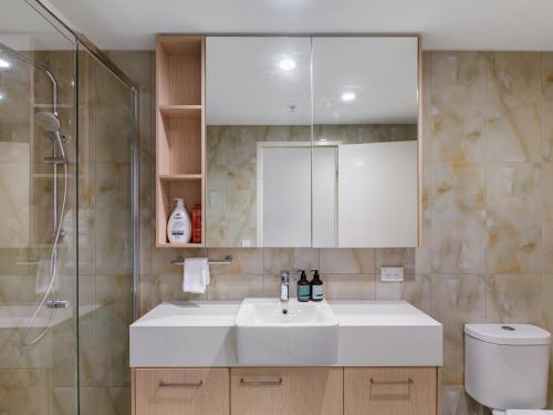 a bathroom with a white sink and a shower at Timi Property in Brisbane