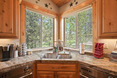 a kitchen with a sink and two windows at 5 Vine Maple in Sunriver