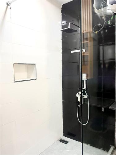 a shower with a glass door in a bathroom at GoodHouse XT in Lekki