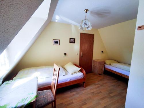 a bedroom with two beds in a attic at HERRNMÜHLE - Pension & Ferienwohnungen in Rothenburg ob der Tauber