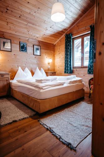 a bedroom with a large bed in a wooden room at Primus Lodge Obertauern in Obertauern