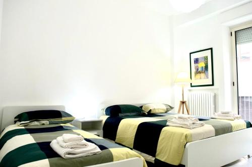 a bedroom with two beds with towels on them at Misve Home in Cosenza