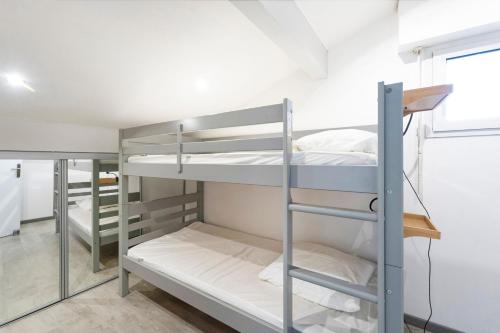 a group of bunk beds in a room at Charmante maison à 200m de la plage in Hossegor