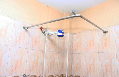 a shower head on a wall in a bathroom at Geed Hotel in Nairobi