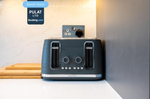 a toaster sitting on a counter in a room at 3BR Flat By Pulat Short Lets & Serviced Accommodation London With Pool Table, SmartTV & AC in London