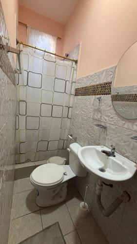 a bathroom with a toilet and a sink at Casa con Piscina Privada in Salinas