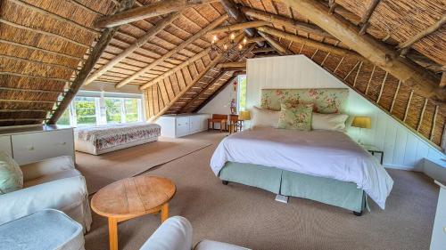 a bedroom with a bed and a couch in a attic at Coppull Private Nature Reserve in Stanford