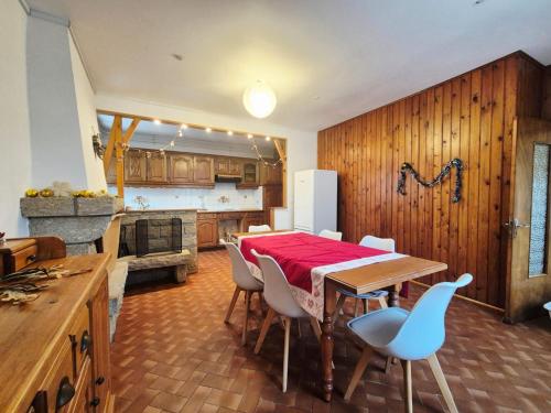a dining room with a table and chairs in a kitchen at La maison d'à côté in Pluherlin