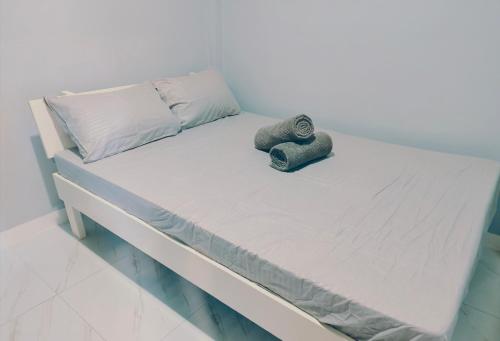 a bed with towels and pillows on it at Casanuestra Apartelle in Panglao