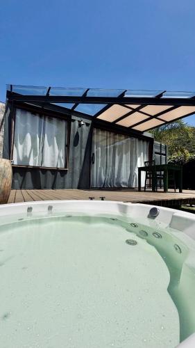 a large pool of water in front of a house at Cabana ECO - Teresópolis in Teresópolis