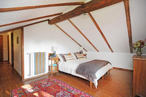 a bedroom with a bed and a rug at Il portico sulla valle, Bioglio in Valle San Nicolao