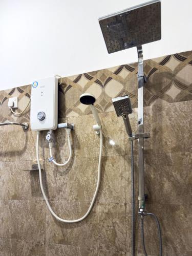 a shower in a bathroom with a shower at JAMI River Side Hotel & Yala Safari Place in Tissamaharama