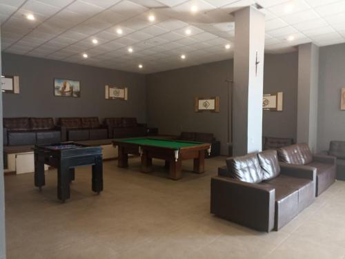 un soggiorno con tavolo da ping pong e divani. di Hotel Balneário ad Angra dos Reis