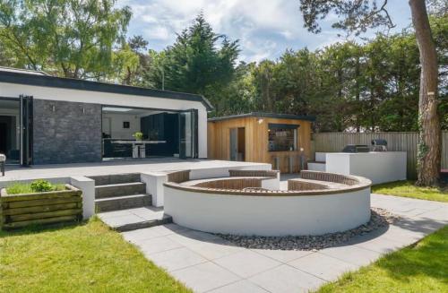 a backyard with a fire pit and a house at Kiwi Pines forest retreat! in Saint Leonards