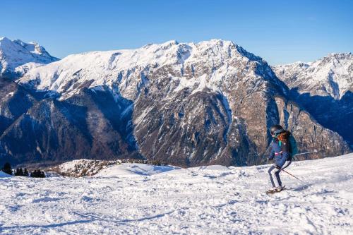 a person on skis standing on a snow covered mountain at Demeure Sauvage - Étage 2 in Villard-Reculas