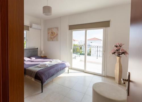 a bedroom with a bed and a sliding glass door at Crystal Villa walk by Merit Casinos By HolidayKeys in Kyrenia
