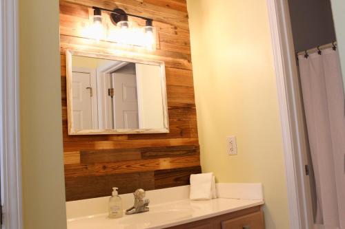a bathroom with a sink and a mirror at The Jr. Suite at 205 Royal Poste Rd. in Sunset Beach