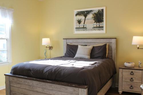 a bedroom with a bed with two lamps and a picture at The Jr. Suite at 205 Royal Poste Rd. in Sunset Beach