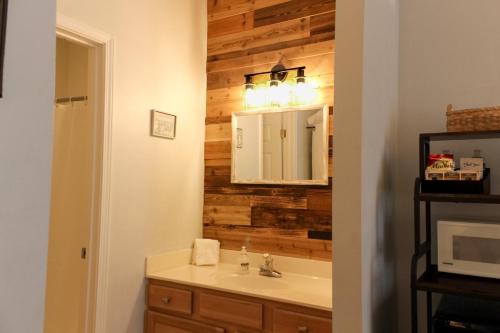 a bathroom with a sink and a mirror at The Suite at 205 Royal Poste Rd in Sunset Beach