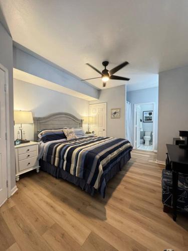 a bedroom with a bed and a ceiling fan at The Villa at 125 Royal Poste Rd in Sunset Beach