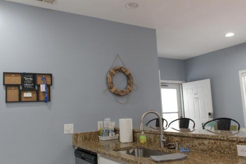 a kitchen counter with a sink and a mirror at The Villa at 125 Royal Poste Rd in Sunset Beach