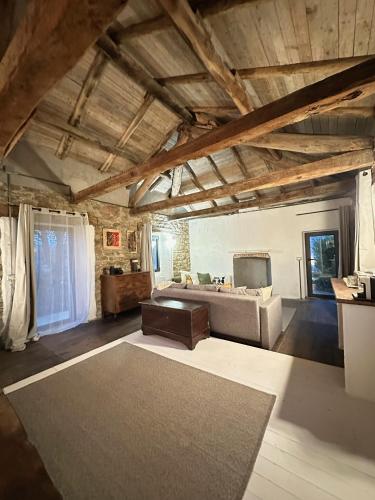 a living room with a couch and a bed at Ca Jurzot in Gorzegno
