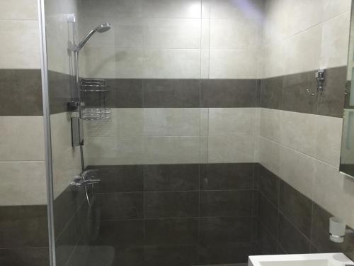 a bathroom with a shower and a sink at Sea Towers 2 room apartment in Batumi