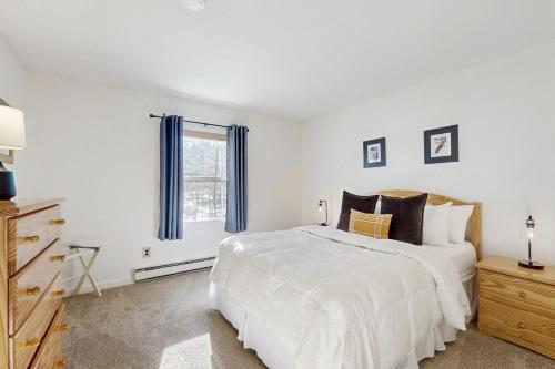a white bedroom with a large bed and a window at Equipe Sport 2E in Dover