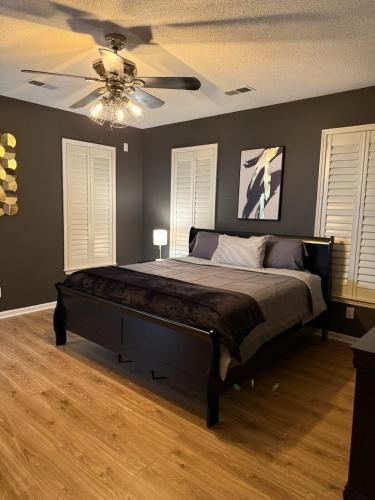 a bedroom with a bed with a ceiling fan at Marion Getaway in Marion