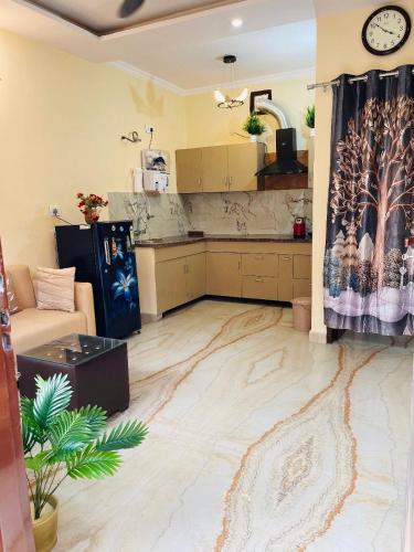 a living room with a marble floor and a kitchen at The Healing Haven in Kharar