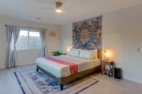 a bedroom with a bed and a painting on the wall at The Maharaja Retreat with Hot Tub and EV Charger! in Yucca Valley