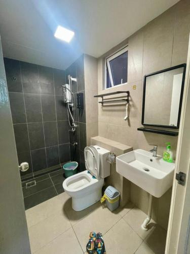 a bathroom with a toilet and a sink at Jhomestay2 in Sandakan