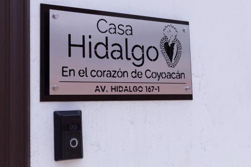 a sign on a wall with a sign for a restaurant at Casa Hidalgo By Mi Querido Coyoacán in Mexico City