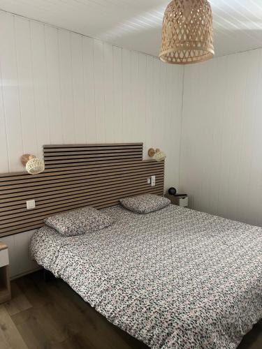 a bedroom with a bed and two pillows on it at renaissance larmane in Eugénie-les-Bains