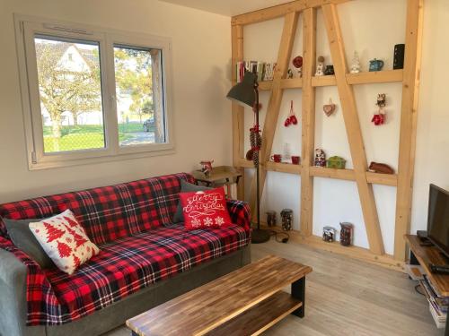 una sala de estar con un sofá y una mesa en Gites au jardin, en Morsbronn-les-Bains